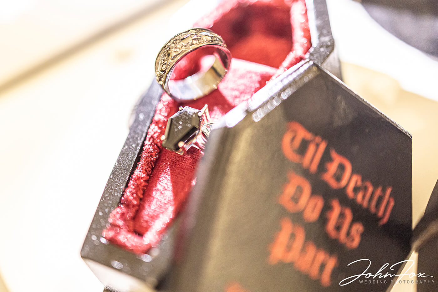 The wedding rings in a miniature coffin case.