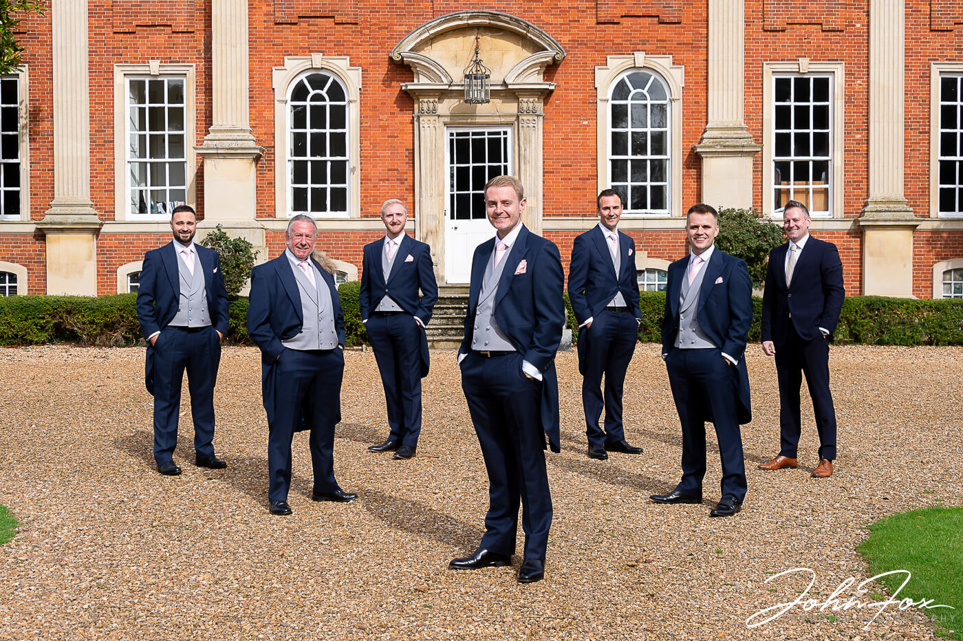 The groom and his entourage outside Chicheley hall, Buckinghamshire
