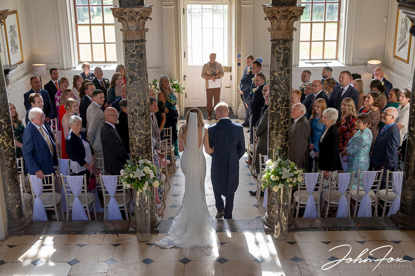 Photo by John Fox Wedding Photography of Lorna's father giving her away at the Wedding ceremony at Chicheley Hall, Buckinghamshire