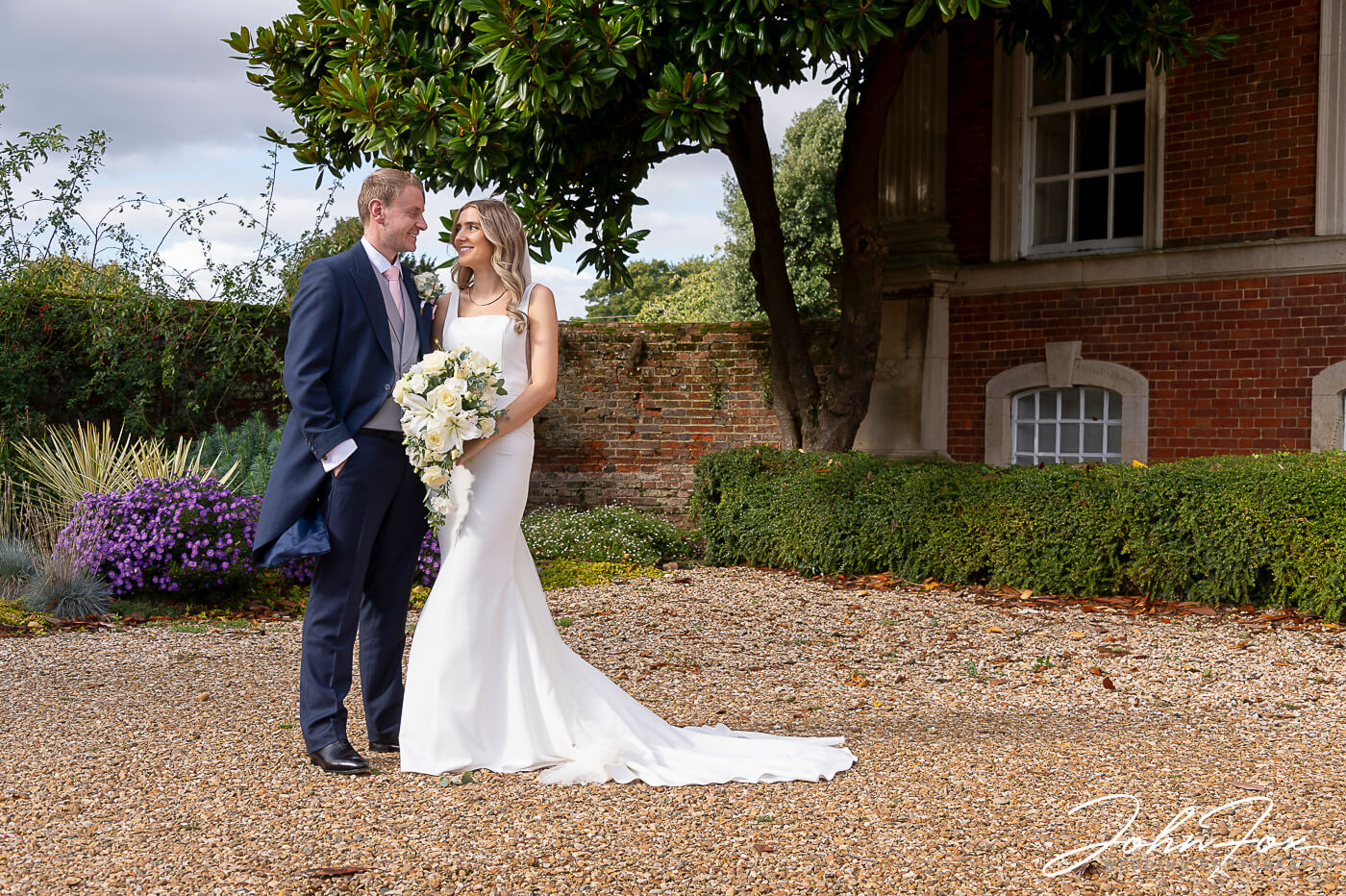 Lorna and James have a quiet moment in the grounds at Chicheley Hall on their wedding day