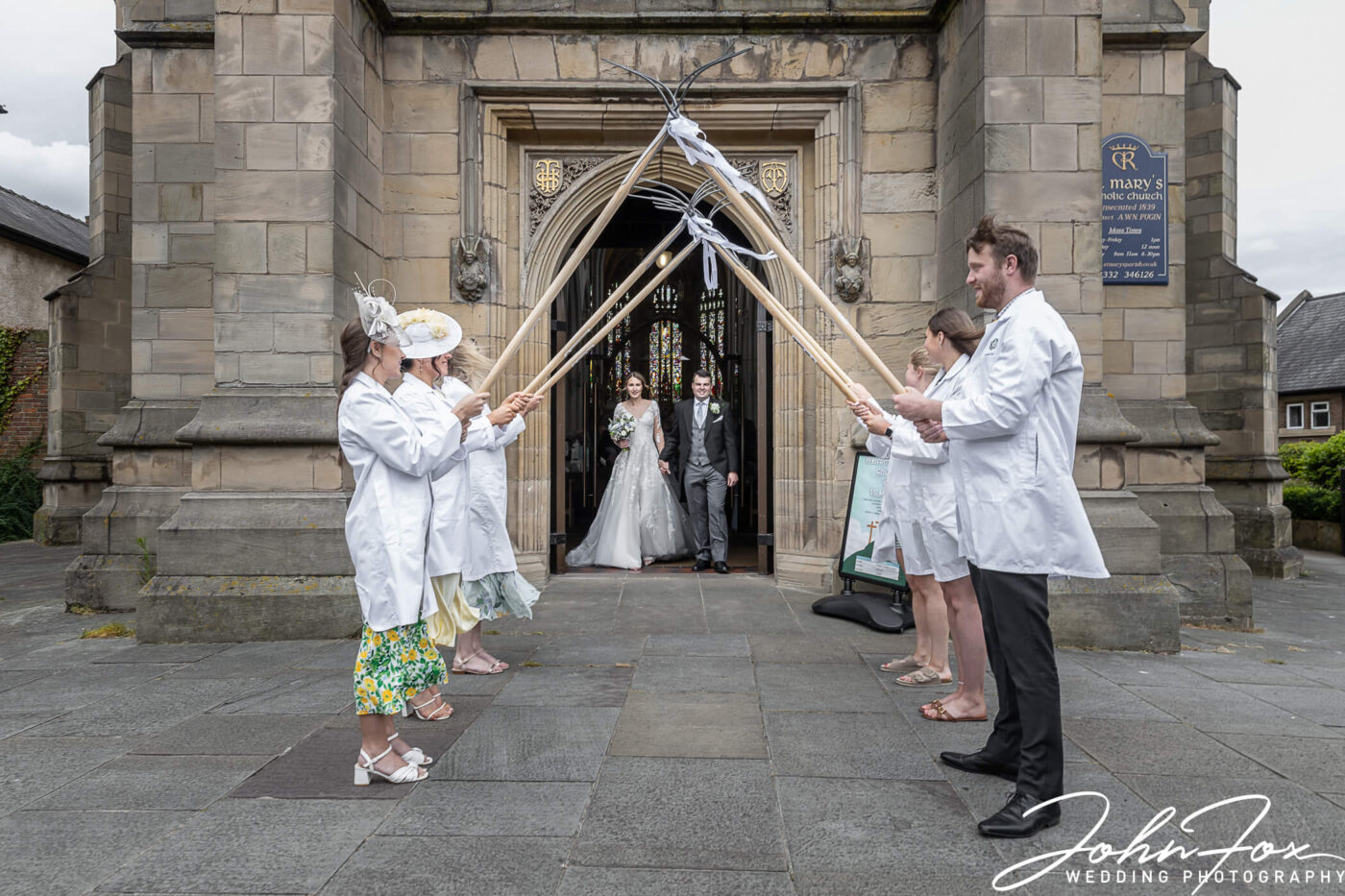 The members of the young farmers group guard of honour as the newly wed couple leave the church in Derby.