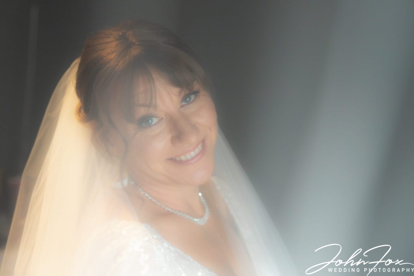 Close-up of the bride at t Meadow Barn at The Stratford Park Hotel by John Fox Wedding Photography