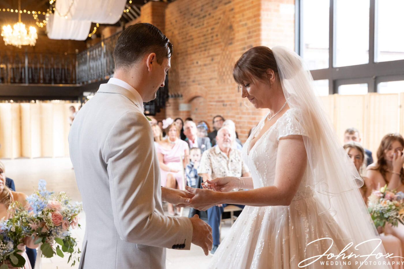 The bride and groom at their wedding ceremony at Meadow Barn, Stratford-upon-Avon.